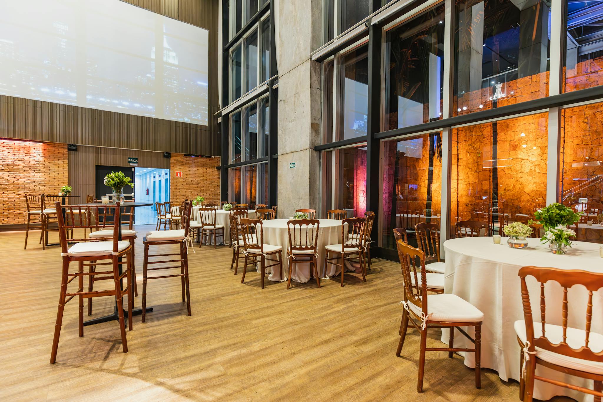 Stylish indoor venue with elegant round tables and chairs, perfect for celebrations.